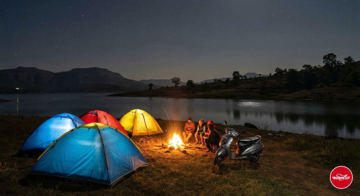 Pawna Lake camping scene near Pune with colorful tents by the lakeside and campfire glowing at night with scooty parked nearby