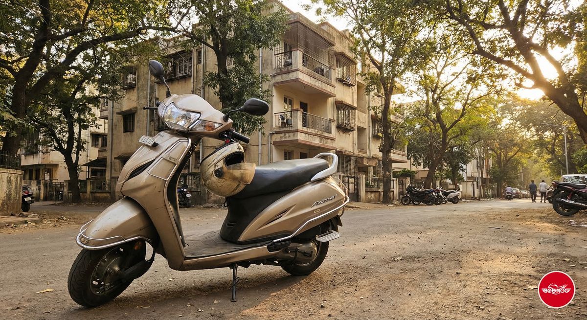 Rental scooty parked outside a PG apartment building in Pune residential area