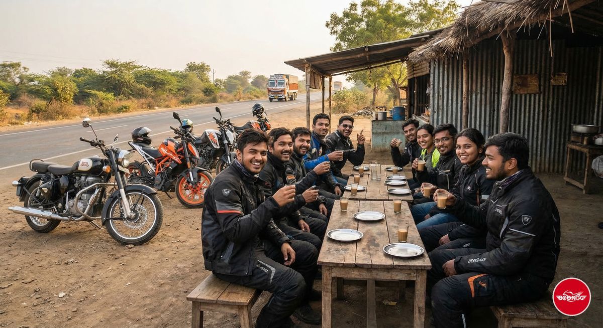 Group of young Indian riders at a roadside dhaba chai stop on a highway with motorcycles parked and friends drinking chai