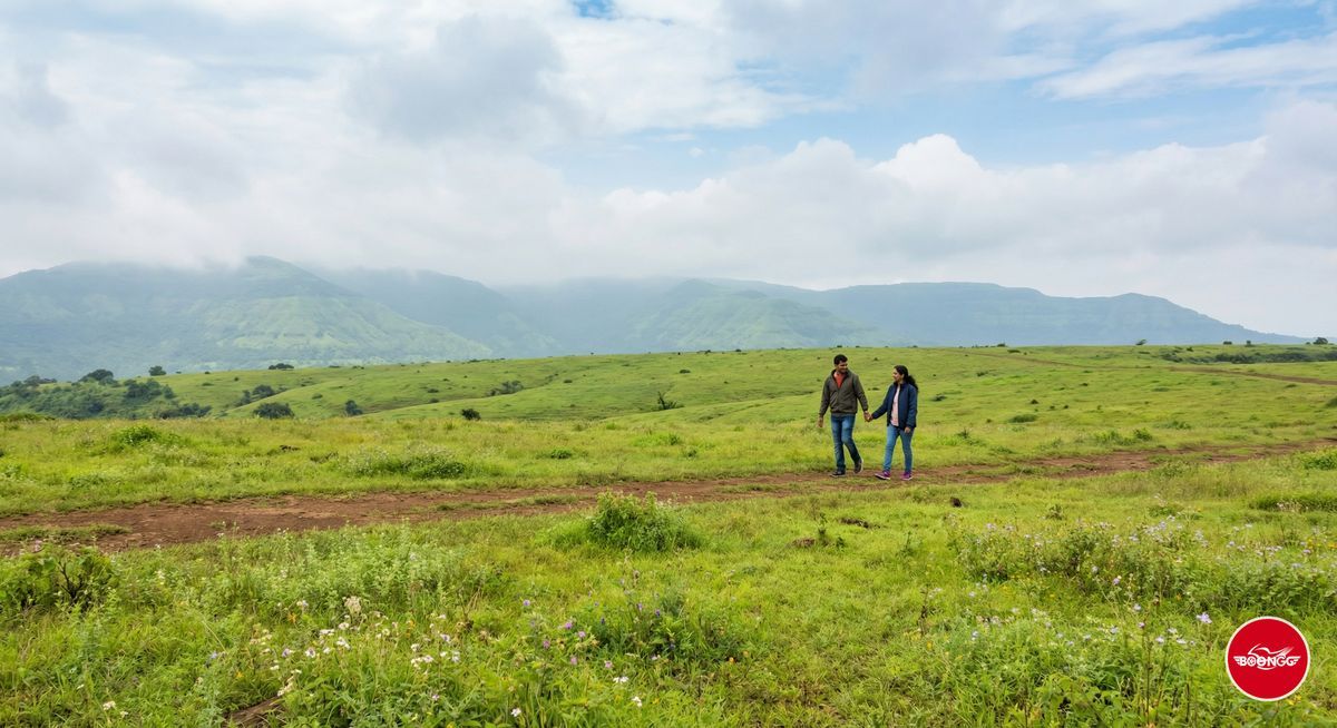 Panchgani Table Land plateau with wide green grassland and hills in background