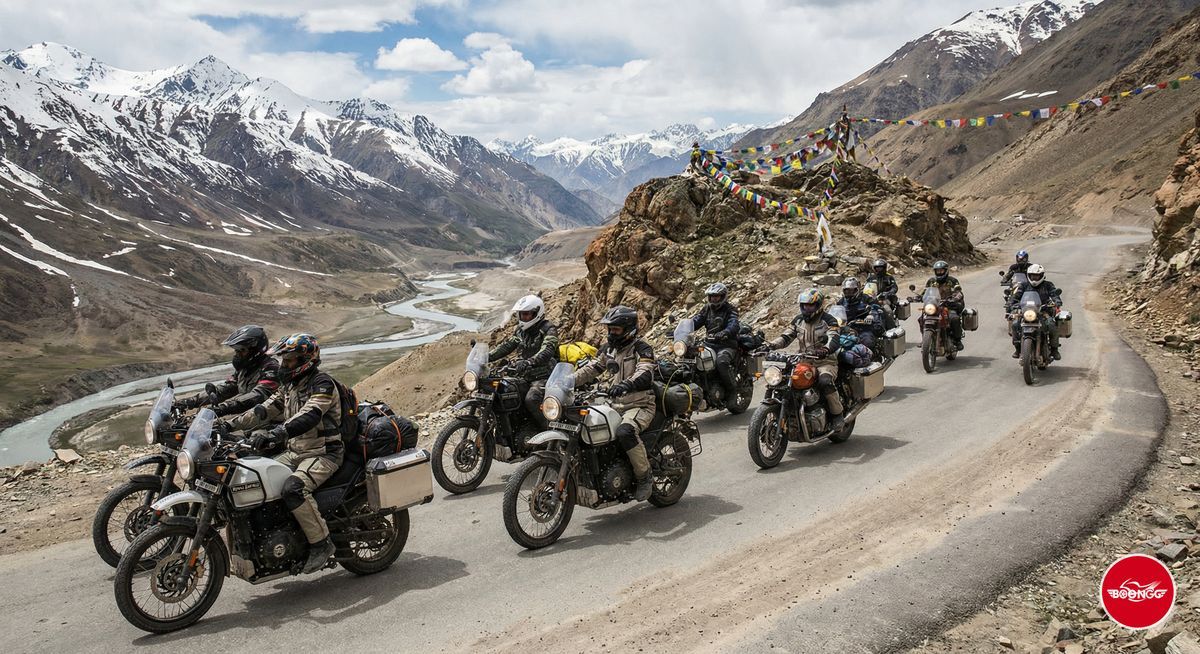 Group of Royal Enfield riders in formation on scenic mountain highway