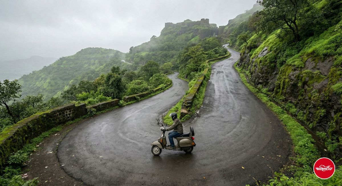Winding ghat road climbing to Sinhagad Fort with scooter rider